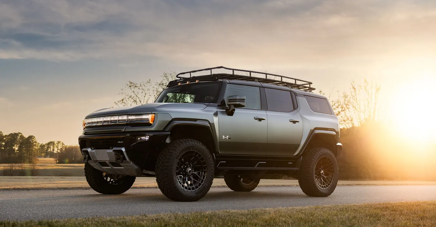 GMC Hummer EV on black off road wheels at sunset